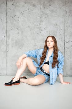 Woman in jeans jacket on studio background