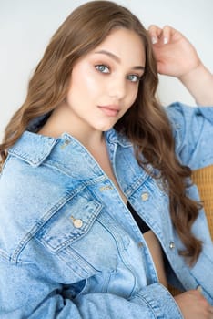 Woman in jeans jacket on studio background