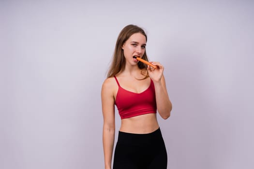 Close-up of woman eating a sausage. Cropped photo in studio