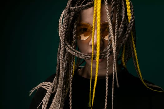 A woman with yellow dreadlocks wearing a black shirt is depicted in this scene. Her unique hair color contrasts strikingly with her dark clothing as she stands confidently.