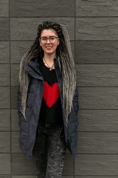 Lifestyle concept, young European woman with pigtails in her hair walking around the city.