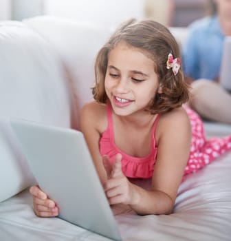 Girl, child and relax on sofa with tablet for games, movies or elearning platform with happiness and development. Internet, streaming and subscription with ebook on online education website at home.