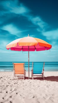 Two chairs and an umbrella on a beach under the sun