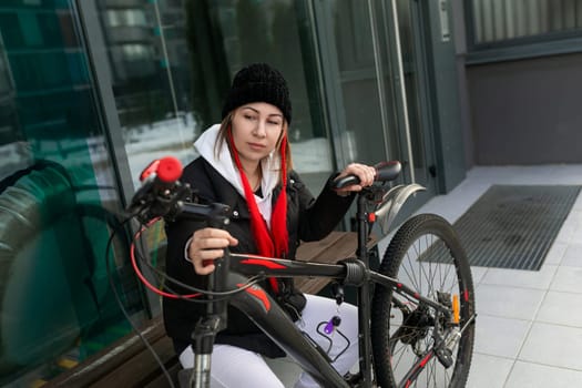 Young woman went out for a bike ride in winter.