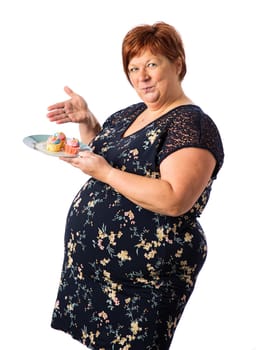 Fifty something woman a plate of cupcakes and presenting them