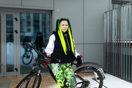 A woman is standing next to a bike parked in front of a building. She appears to be taking a break or checking directions. The scene captures urban life with a touch of transportation and leisure.