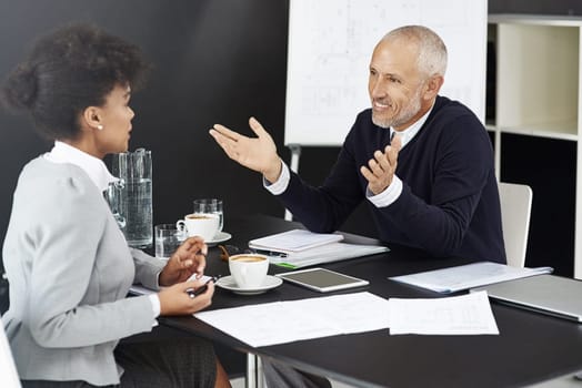 Mature CEO, woman or business people with paperwork in office for talking or speaking of documents. Team, mentor and financial consultants in conversation, communication and discussion in workplace.