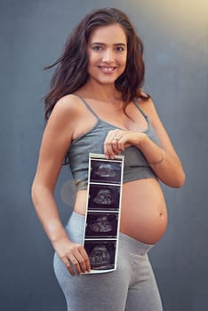 Mother, pregnant and ultrasound in studio with portrait for maternity shoot, album and baby shower. Woman, body and sonogram isolated on gray background for gender reveal, surrogacy and adoption.