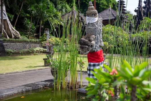 Indonesian Deity Statue in a garden by a pond