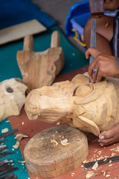 An Artisan Carving an Indonesian Decoration