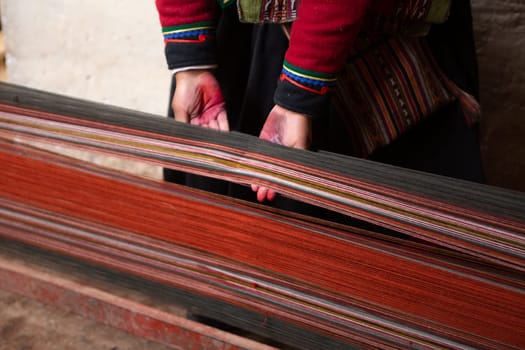 Peruvian Woman Weaving cloth to sell