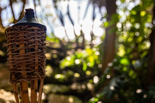 Unlit tiki torch set up for a party