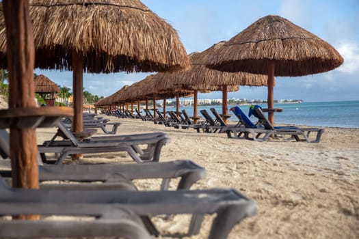 Rows of Palapas  and beach chairs with no people