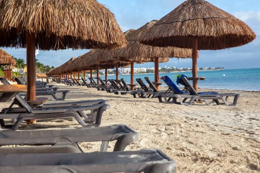 Rows of Palapas and beach chairs with no people