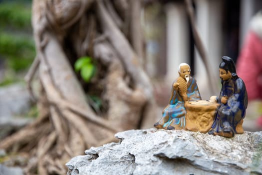 Vietnamese Figurines playing a game with copy space