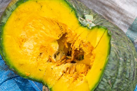 Green pumpkin at a market sliced open to show the inside