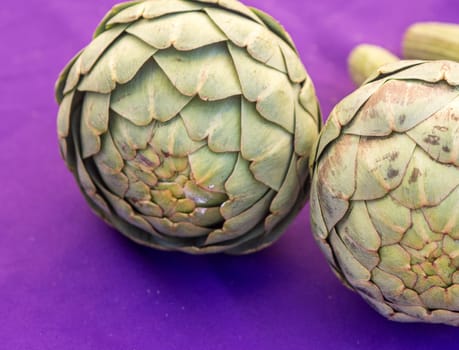 Pair of Artichokes on purple background
