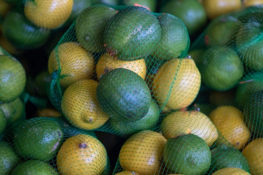 Bags of lemons and limes at the market