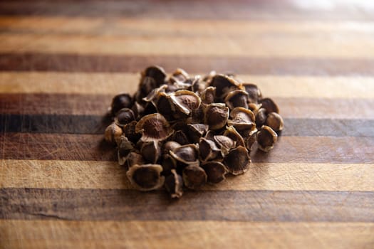 Dried Moringa Seeds on a chopping board