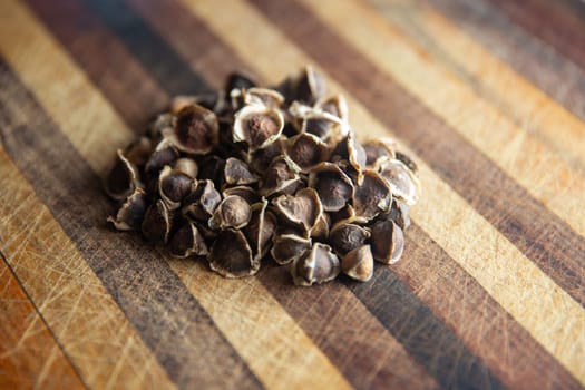 Dried Moringa Seeds on a chopping board
