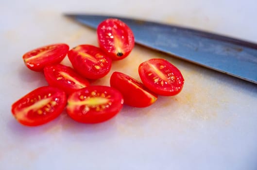 Sliced Tomatoes with the Knife placed on the board