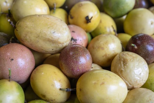Passionfruit sliced on display on a grocery rack