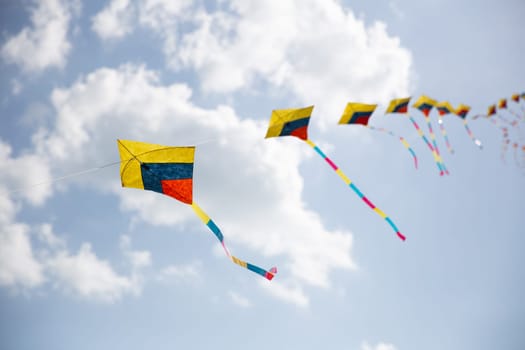 Colorful Kites in Sync Flying at a festival