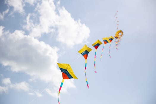 Colorful Kites in Sync Flying at a festival