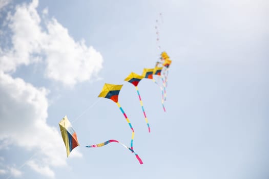 Colorful Kites in Sync Flying at a festival
