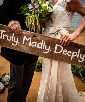 Truly. Madly. Deeply painted sign on wood