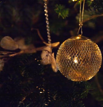Golden Hanging Christmas Ornament on a tree