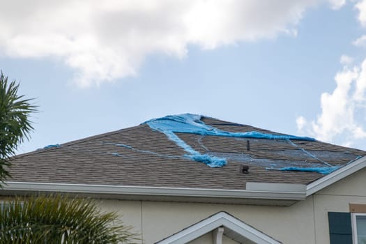 Destroyed Tarp on the roof waiting to get repaired