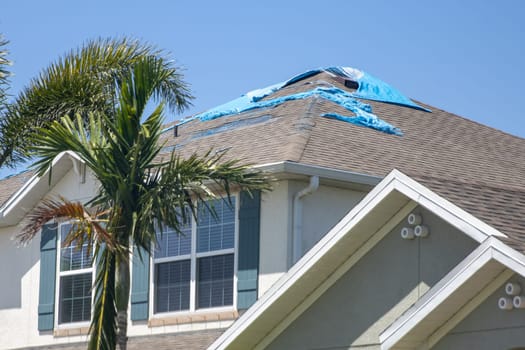 Destroyed Tarp on the roof waiting to get repaired