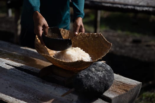 Villager making salt to sell for help for his village