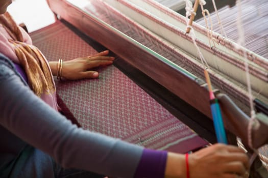 Villager Weaving on a loom in Cambodia