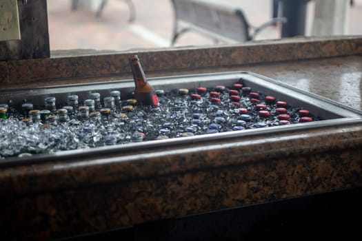 Beers chilling on ice at a bar