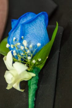 Blue rose boutonniere for the groom