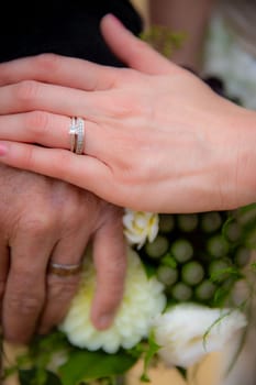 Bride and Groom with Wedding rings on a bouquet