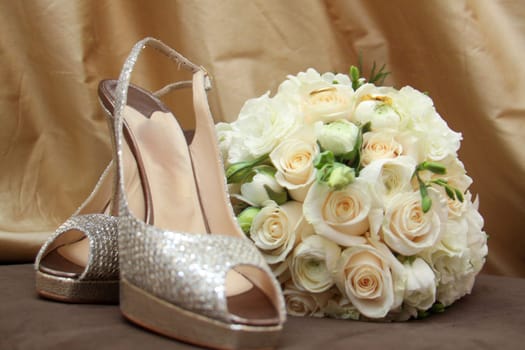 Rhinestone heels and bouquet holding the wedding bands