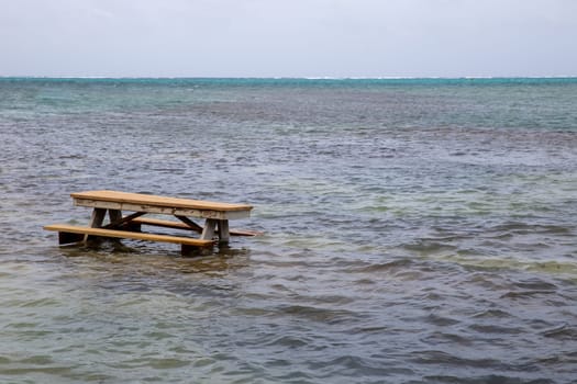 Picnic bench in the water during high tide
