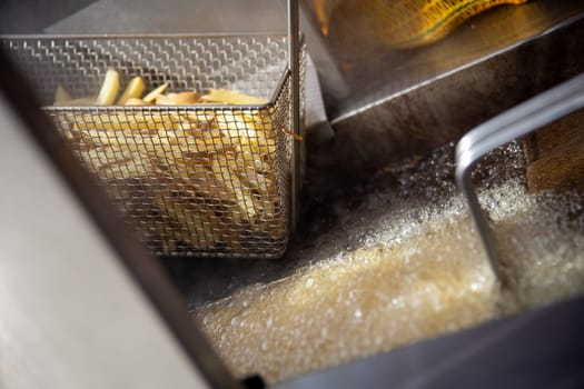 Sizzling hot fries in the fryer