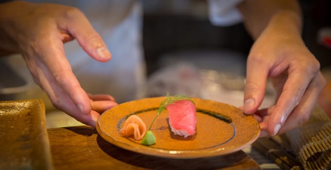Japanese chef serving sushi shot close up