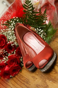 Red heels and bouquet for a wedding