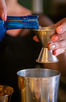 Pouring a shot to be mixed and served