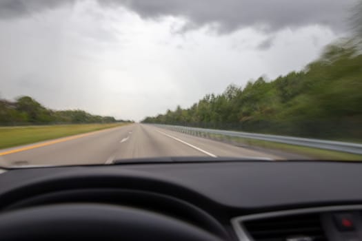 Car driving fast showing blurred motion