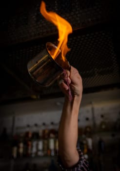 flare bartender pouring the alcohol on fire