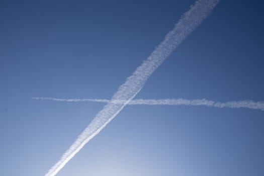 Chemical trails in the sky making an X