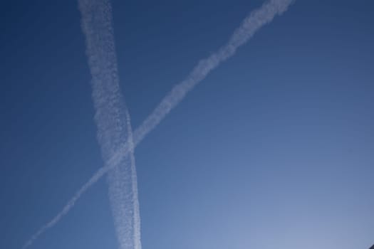 Chemical trails in the sky making an X