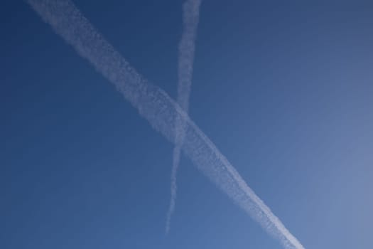 Chemical trails in the sky making an X