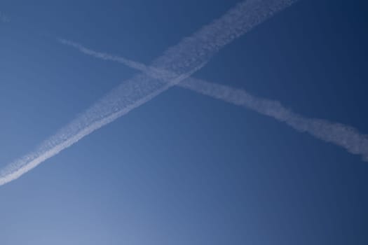 Chemical trails in the sky making an X